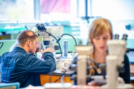 two students in the lab using microscopes